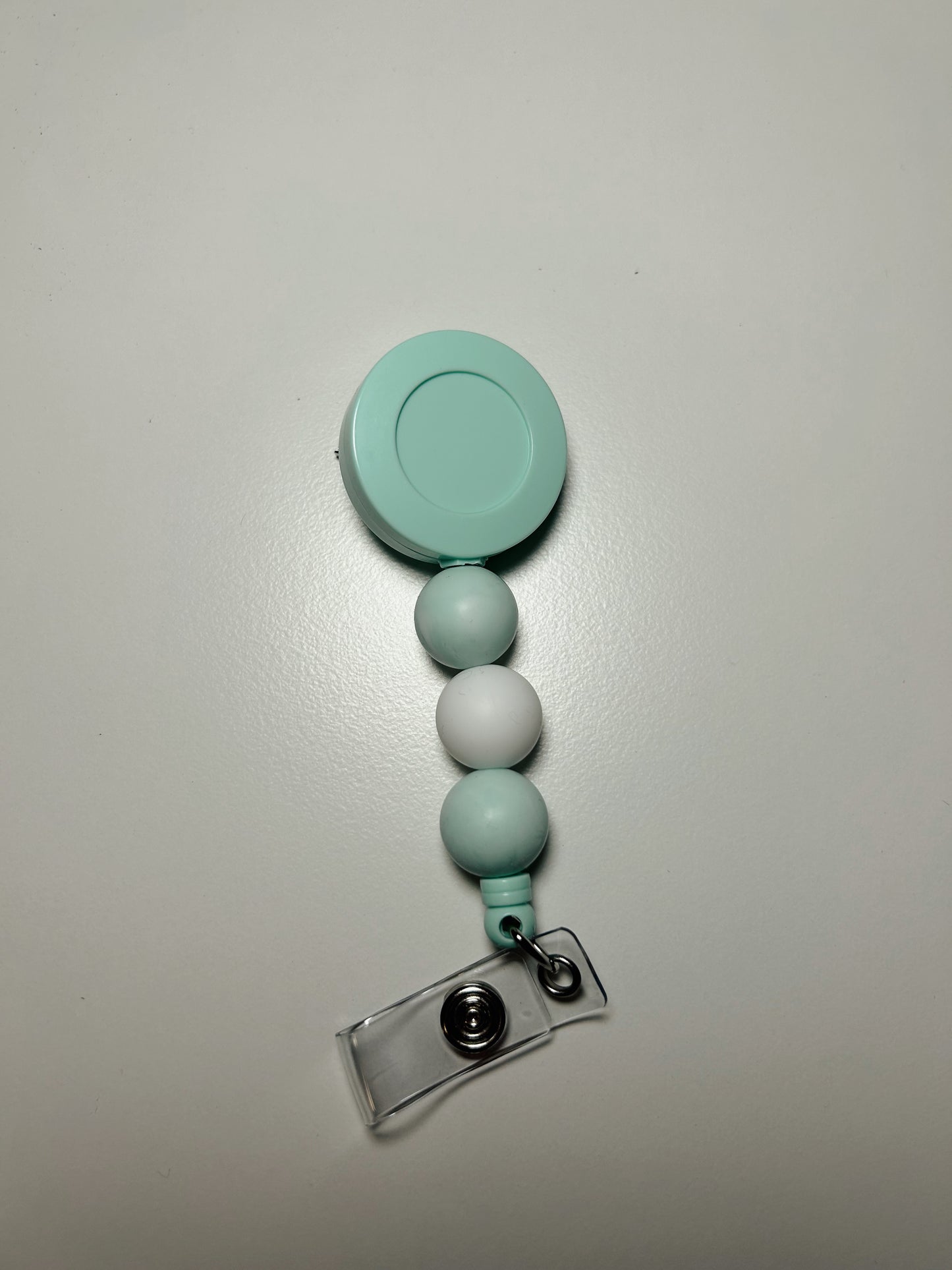 teal badge reel