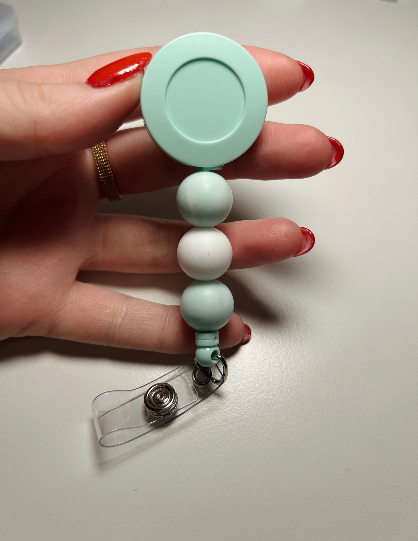 teal badge reel