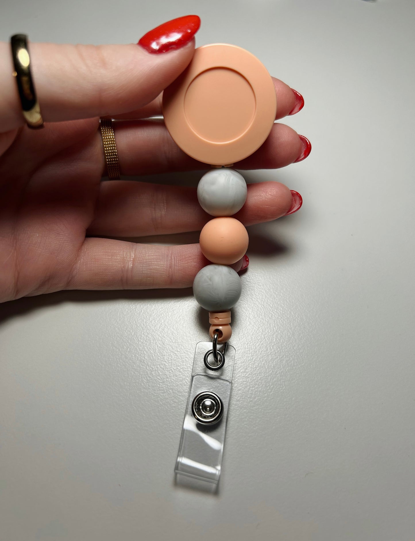 peach badge reel